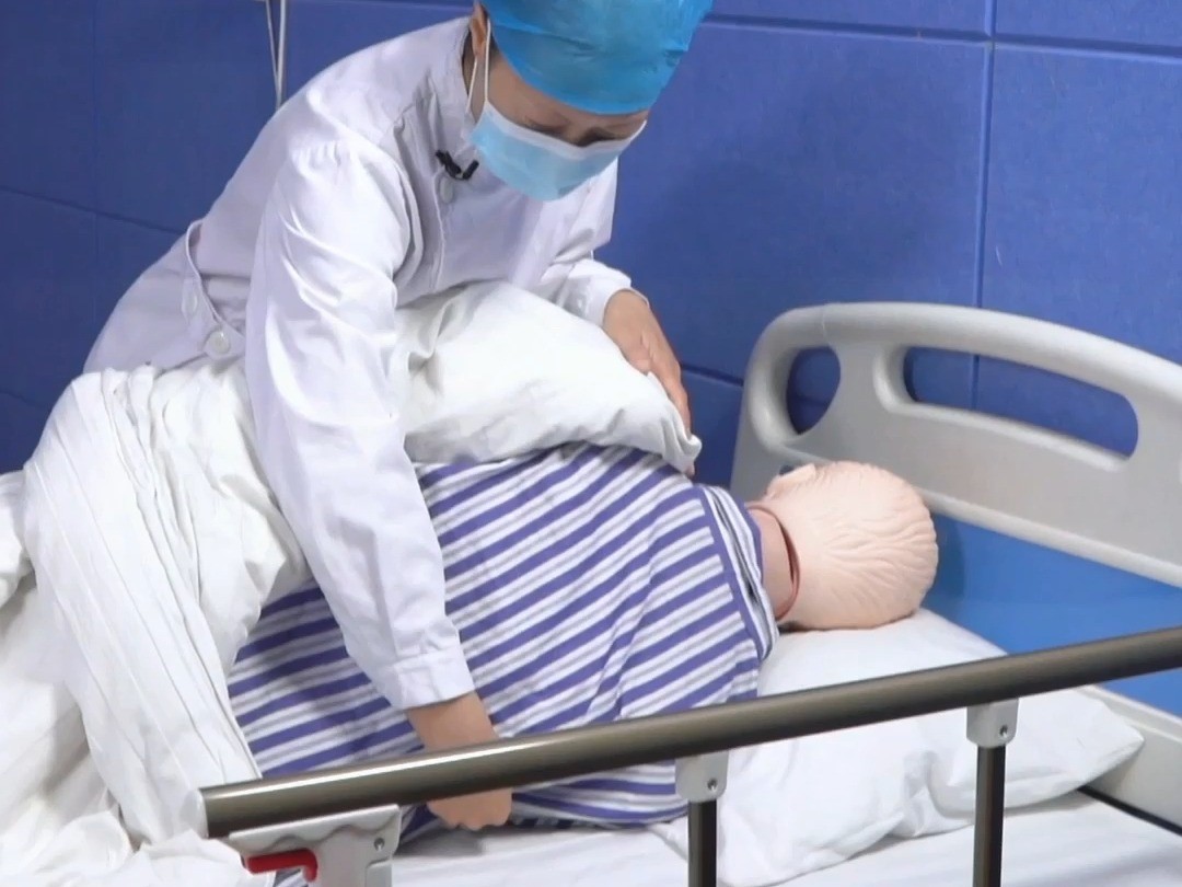 护理员帮助卧床老人正确翻身